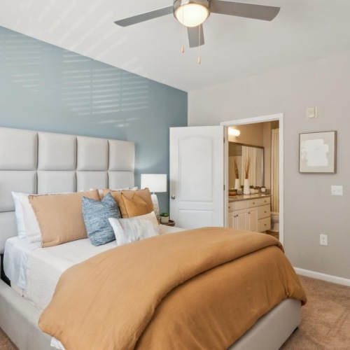 a bedroom with a bed and a fan