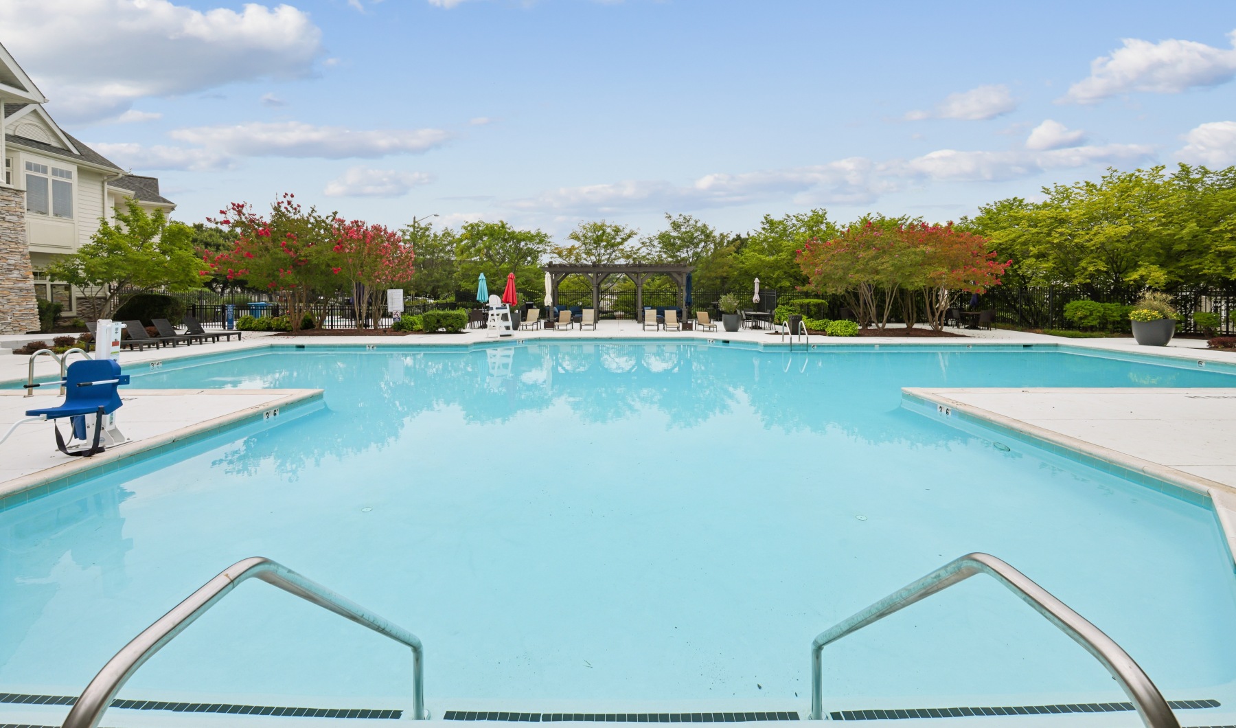 a swimming pool surrounded by trees and buildings